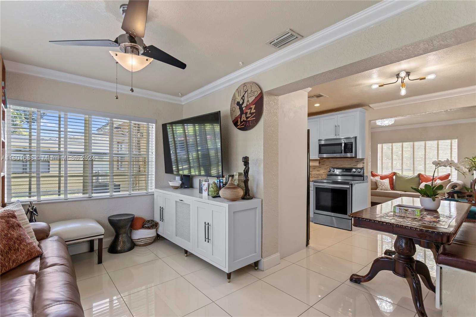 2919 Southwest 68th Avenue Miramar, FL 33023 - Photo 39 of 46 a living room with furniture a flat screen tv and a window