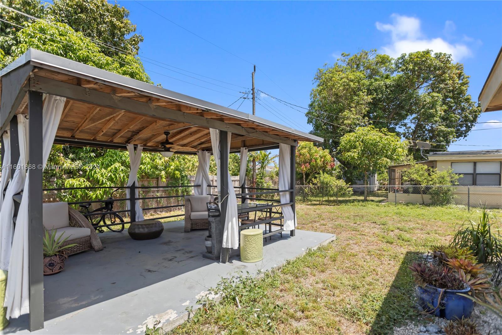 2919 Southwest 68th Avenue Miramar, FL 33023 - Photo 46 of 46 a backyard of a house with a garden and outdoor seating