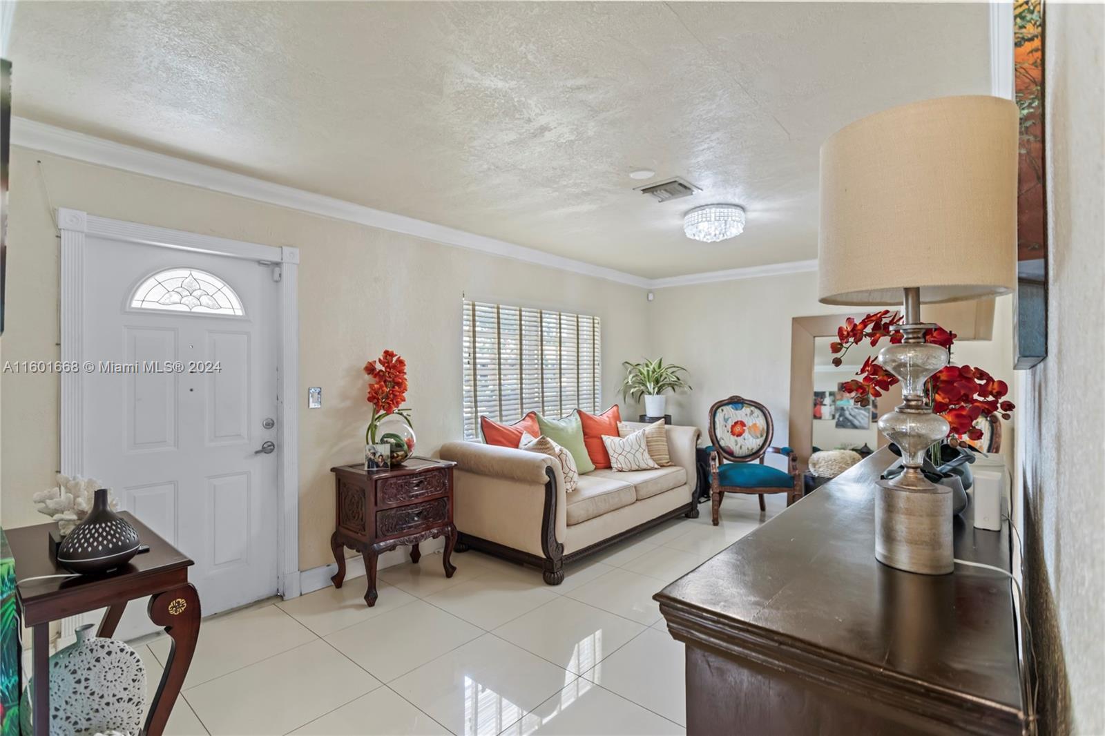 2919 Southwest 68th Avenue Miramar, FL 33023 - Photo 9 of 46 a living room with furniture flowerpot and a chandelier