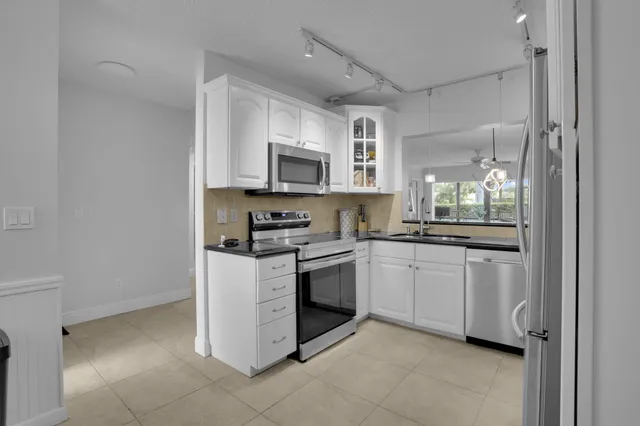a view of a hallway with workspace and a window