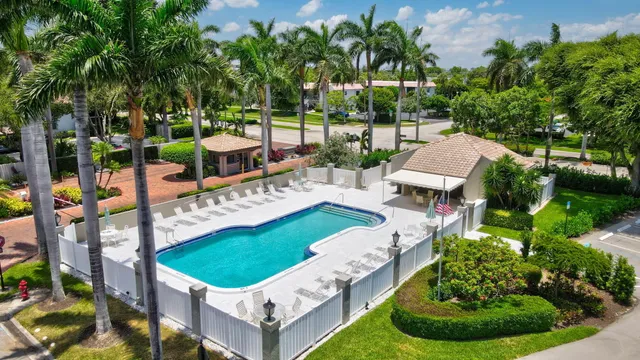 a view of a patio with table and chairs potted plants