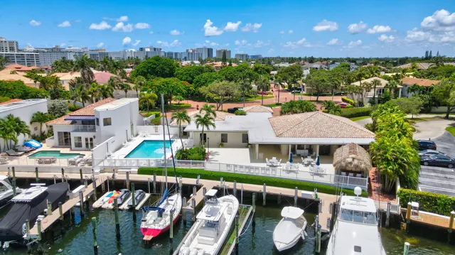 an aerial view of a house with swimming pool and outdoor seating