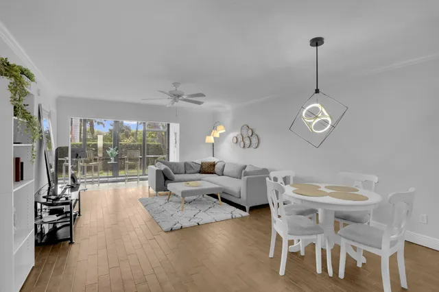 a living room with furniture a flat screen tv and a large window