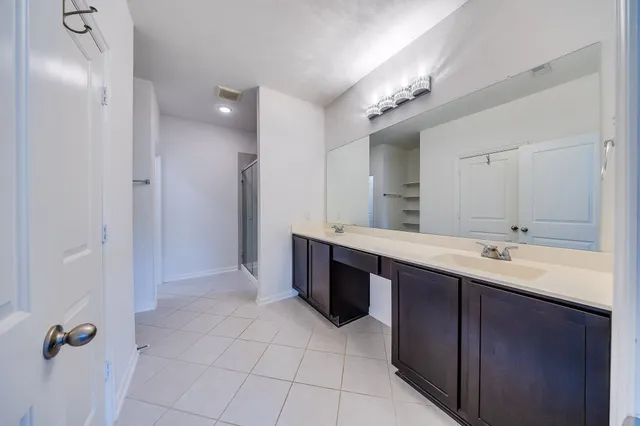 a bathroom with a shower and a glass door