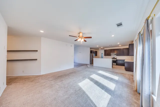 a view of a kitchen with a sink and a window