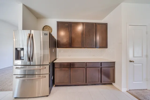 a view of a hallway with cabinets