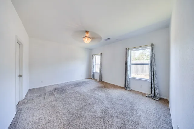 a spacious bathroom with a double vanity sink a mirror and a shower