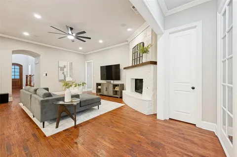 a living room with furniture a fireplace and a flat screen tv