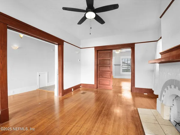 wooden floor in an empty room with a window