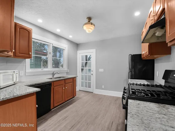 a kitchen with stainless steel appliances a stove sink and cabinets