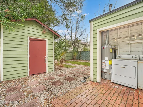 an aerial view of residential house with outdoor space and parking