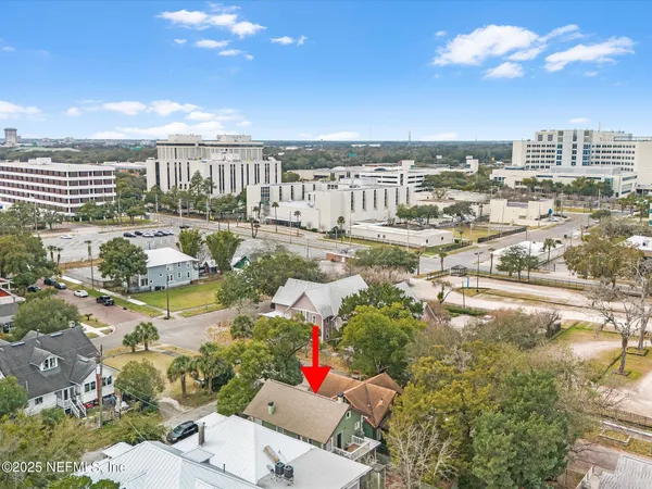 an aerial view of a house with a yard