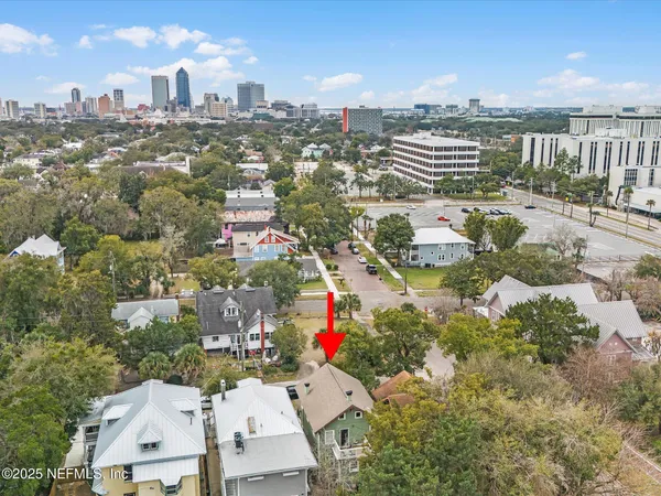 an aerial view of residential houses with city view