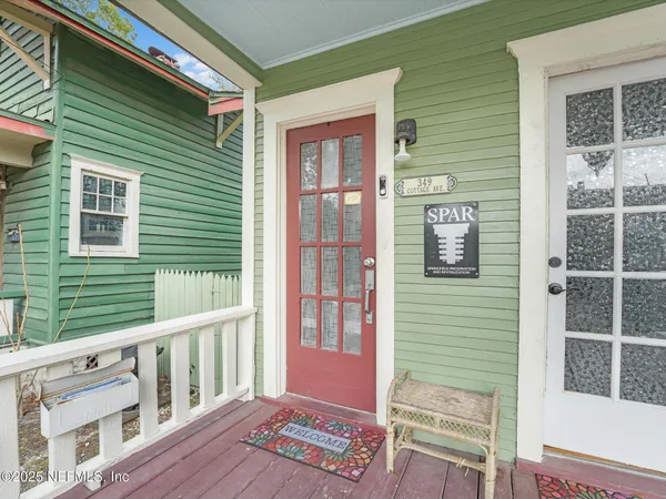 a balcony with wooden floor and windows
