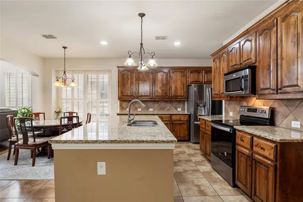 a kitchen with a stove microwave and cabinets