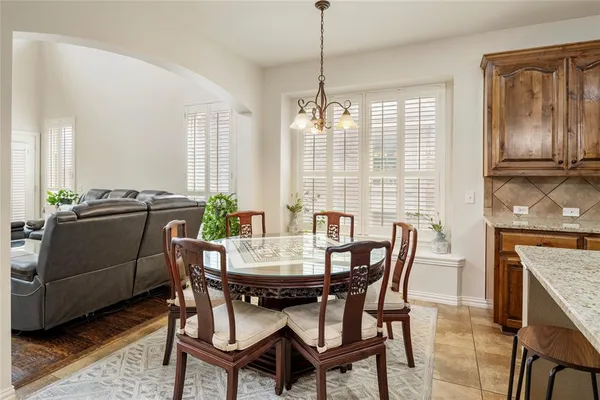 a kitchen with stainless steel appliances granite countertop a sink refrigerator stove and microwave