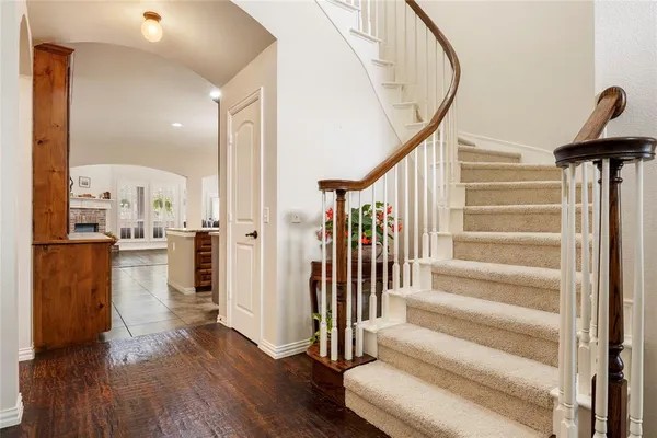 a view of entryway and hall with wooden floor