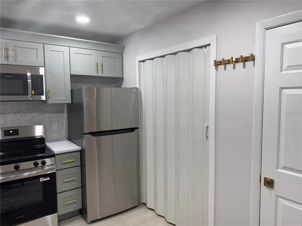 a kitchen with stainless steel appliances a refrigerator and a stove top oven