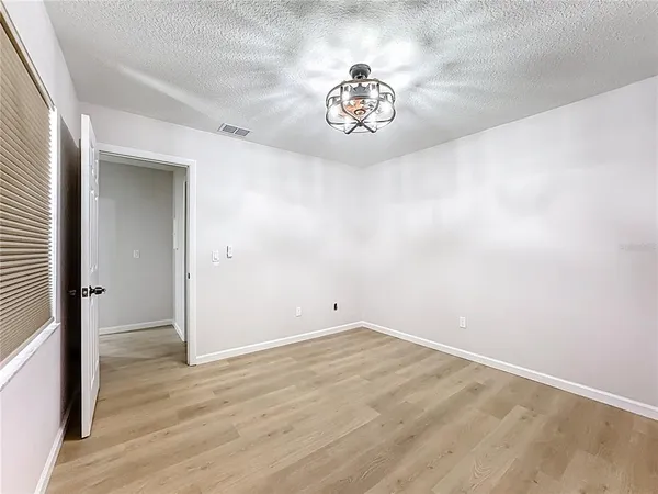 en empty room with wooden floor