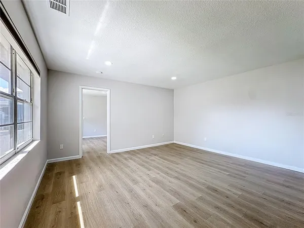 wooden floor in an empty room with a window