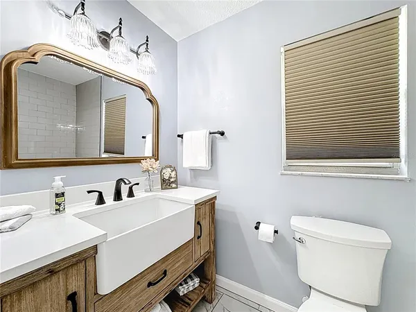 a bathroom with a toilet a sink and mirror