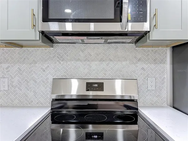 a stove top oven sitting inside of a kitchen