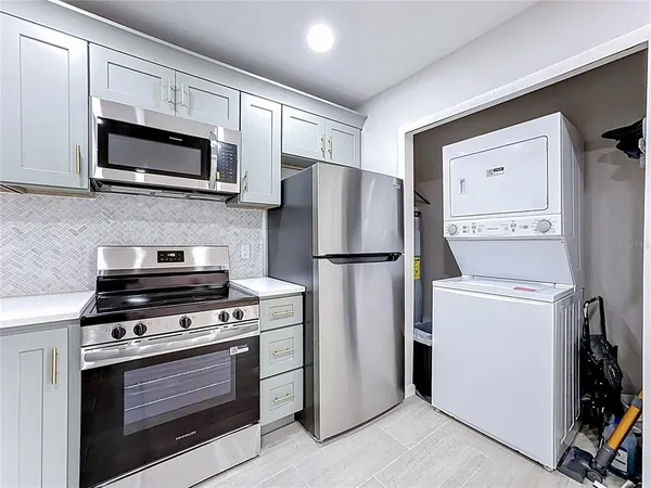 a kitchen with a refrigerator stove and microwave