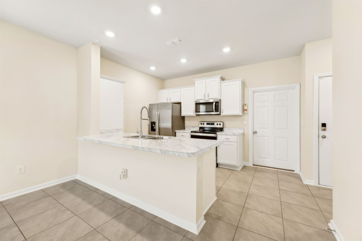 86440 Shortline Circle Yulee, FL 32097 - Photo 13 of 50 a kitchen with stainless steel appliances a refrigerator sink and microwave