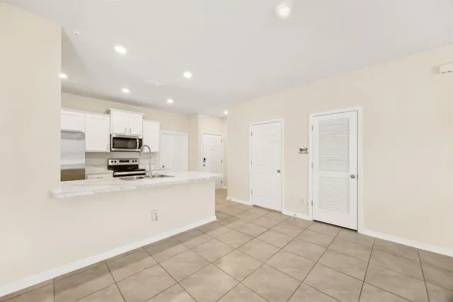 a kitchen with stainless steel appliances a refrigerator sink and stove