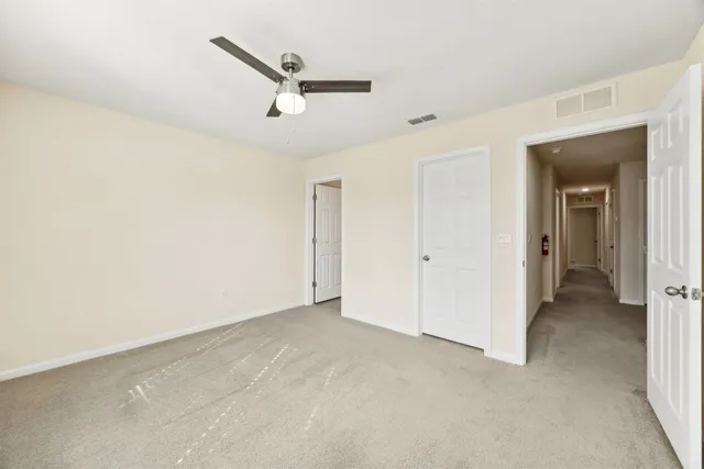 a view of a livingroom with a ceiling fan and wooden floor