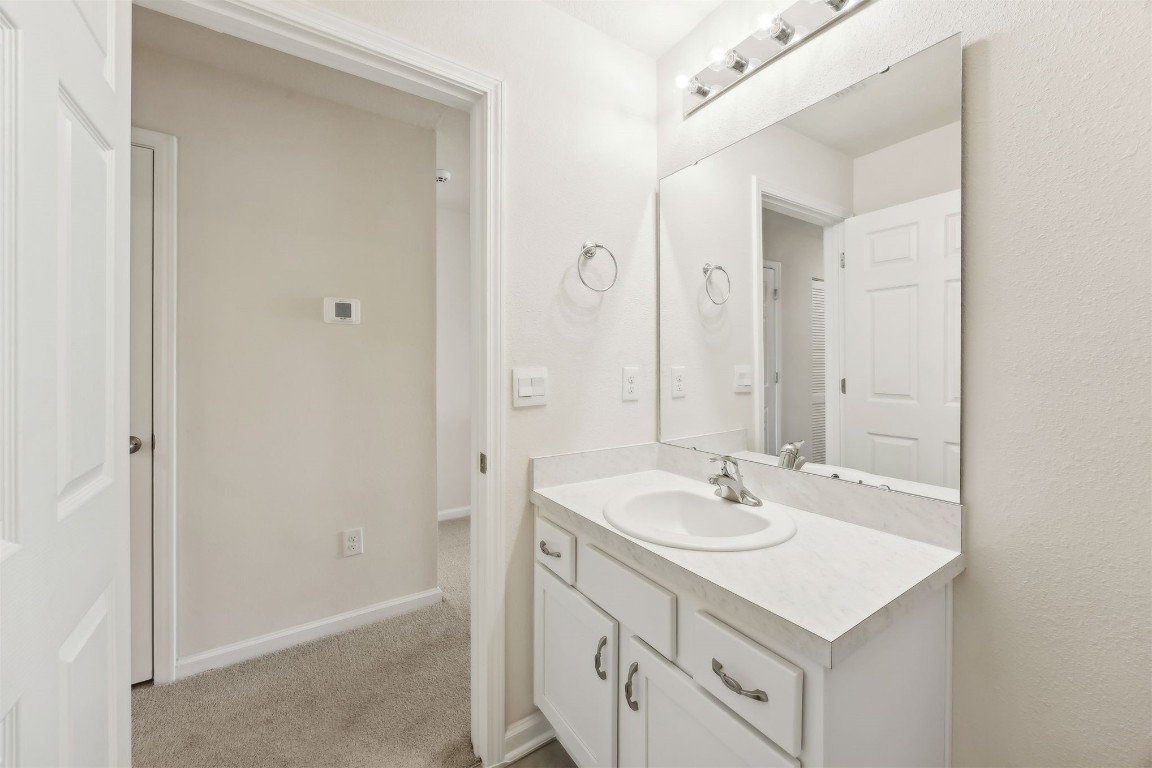86440 Shortline Circle Yulee, FL 32097 - Photo 34 of 50 a bathroom with a sink a vanity and a mirror