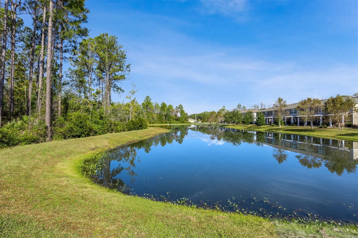 86440 Shortline Circle Yulee, FL 32097 - Photo 9 of 50 a view of a lake with houses in the back