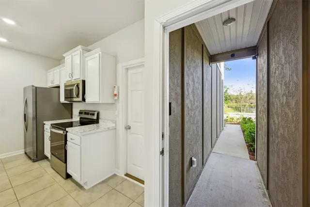 a view of a kitchen with refrigerator and a stove