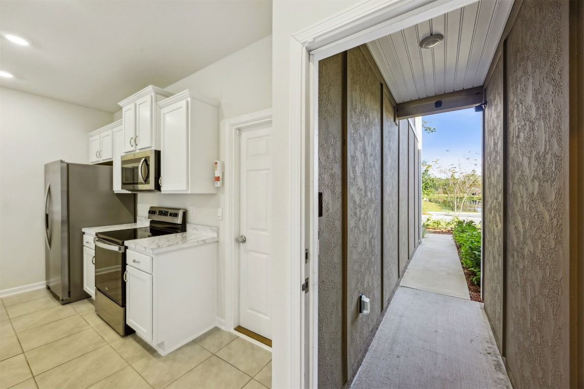 86440 Shortline Circle Yulee, FL 32097 - Photo 10 of 50 a view of a kitchen with refrigerator and a stove