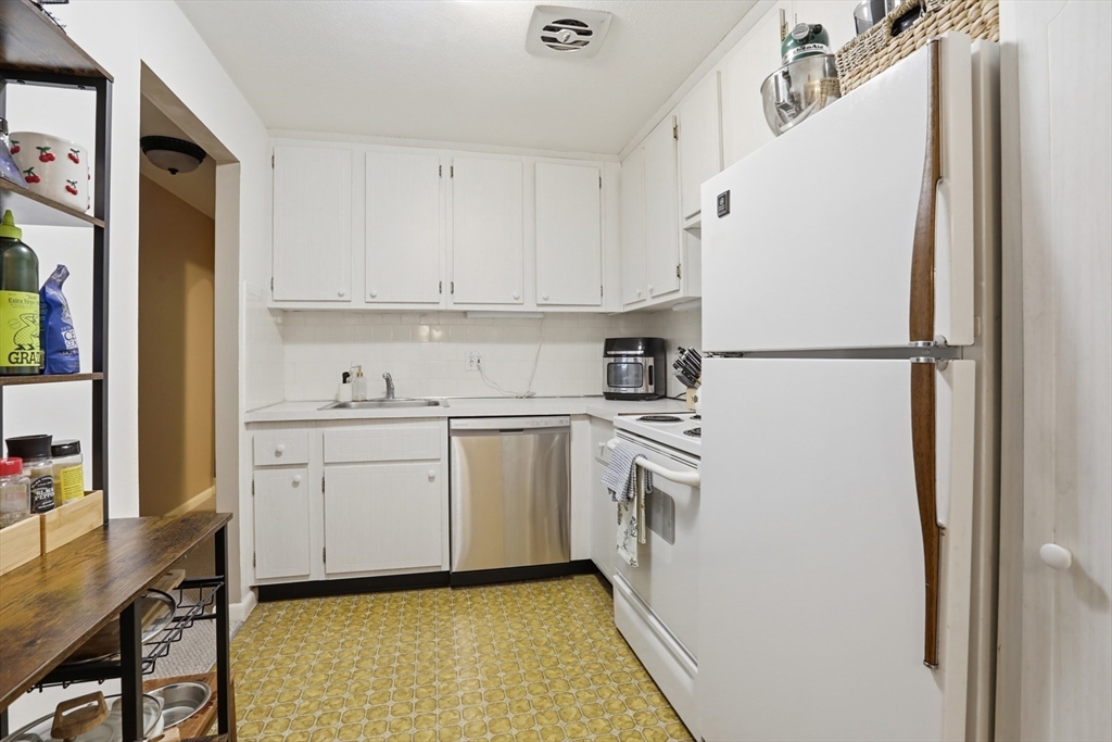 1 Colonial Drive, Unit B1 Andover, MA 01810 - Photo 6 of 14 a white refrigerator freezer sitting in a kitchen