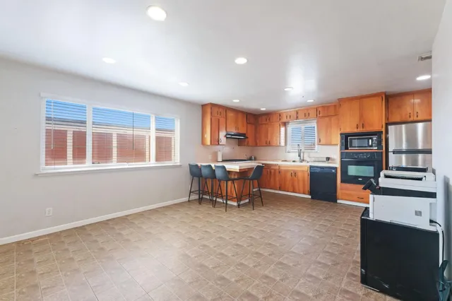 a kitchen with a table and chairs in it