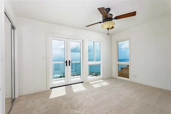 a view of a room with window and a ceiling fan