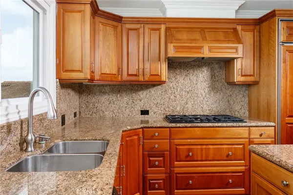 a kitchen with granite countertop a sink and cabinets
