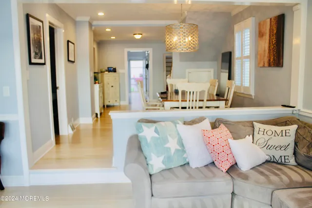 a living room with furniture and a chandelier
