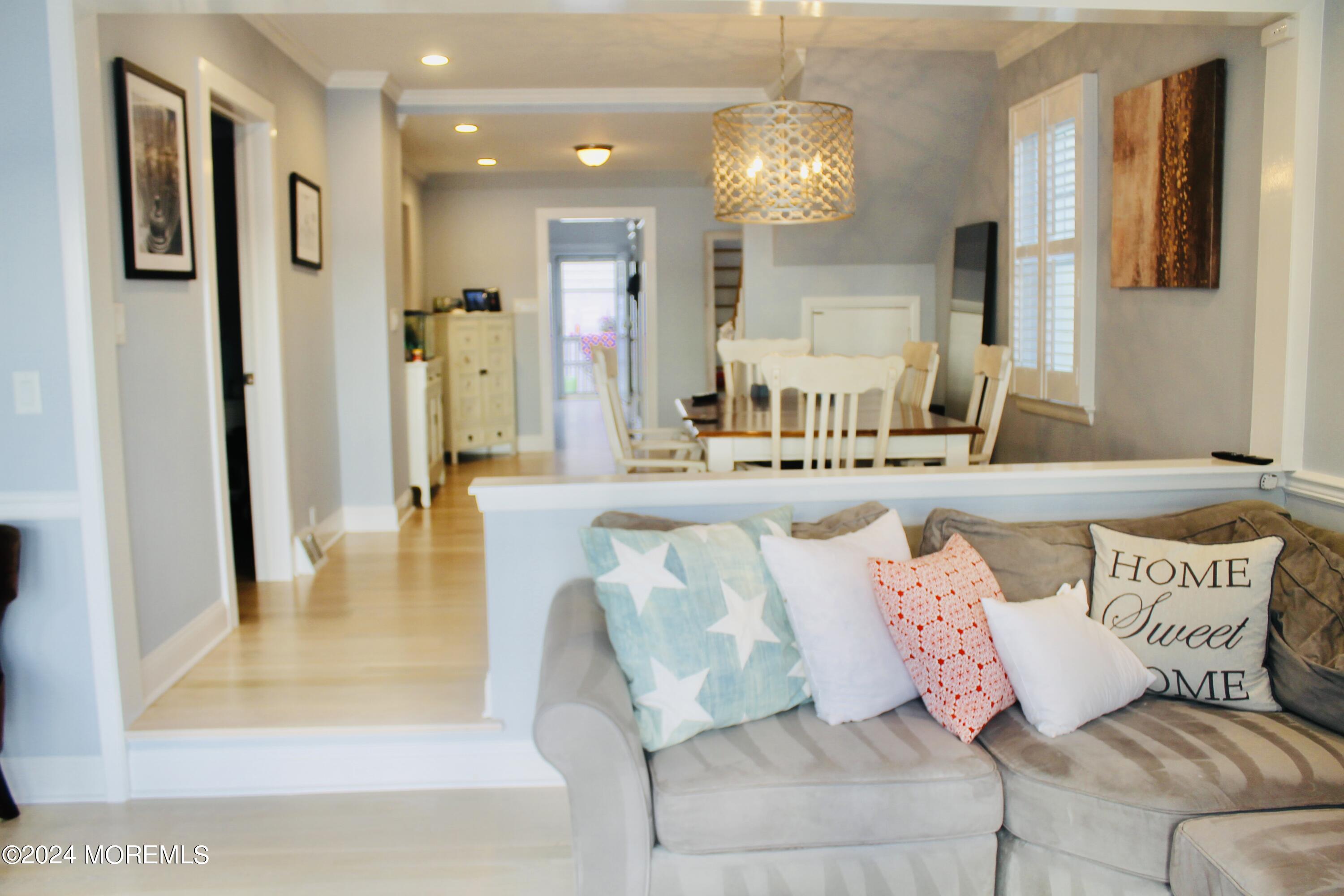 4 Riverview Place Sea Bright, NJ 07760 - Photo 13 of 17 a living room with furniture and a chandelier