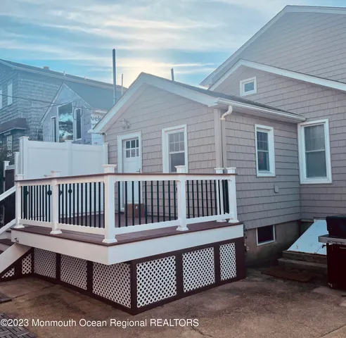 a view of a house with a wooden deck
