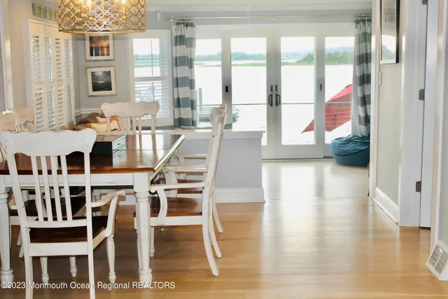 a view of a dining room with furniture wooden floor and chandelier