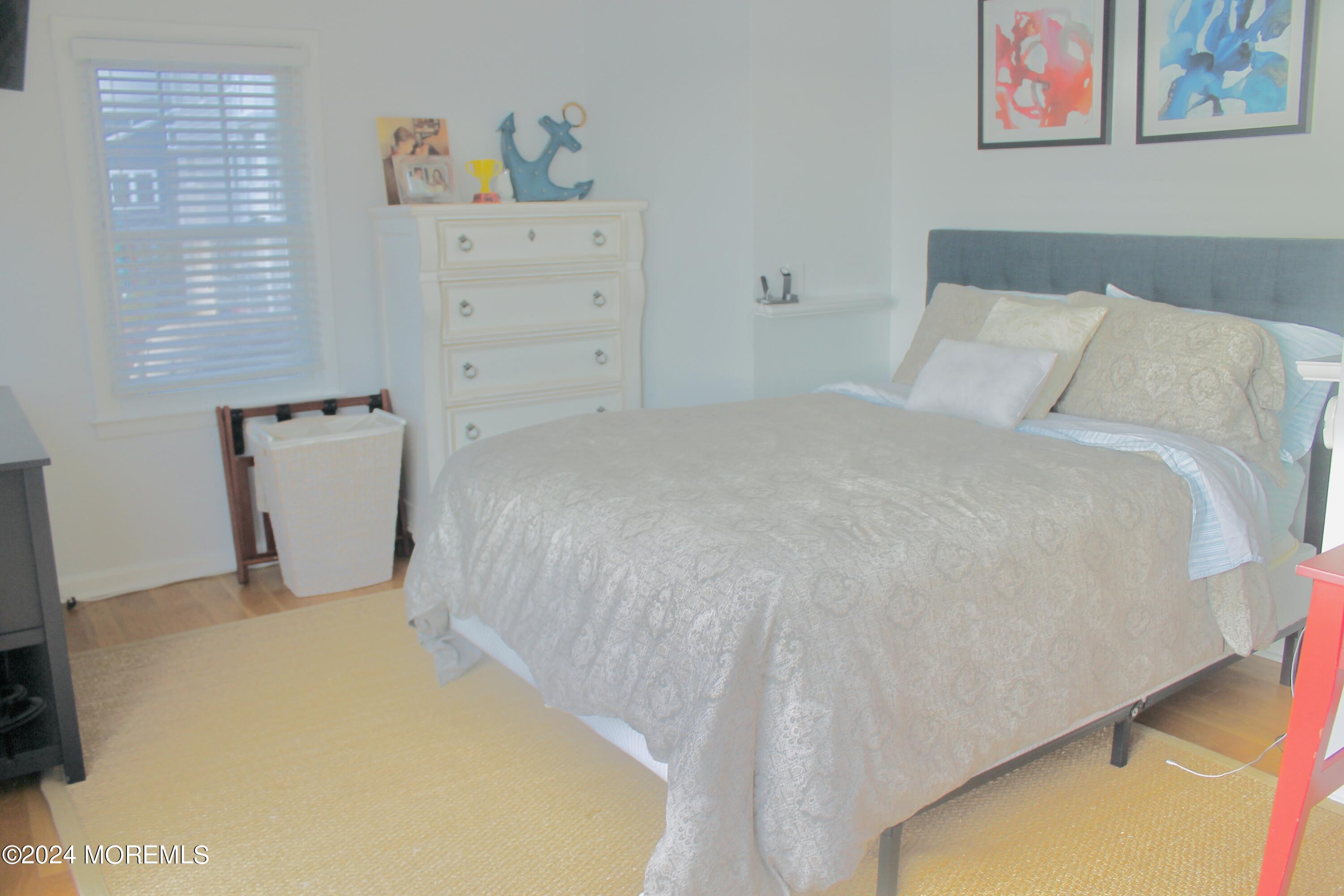 4 Riverview Place Sea Bright, NJ 07760 - Photo 7 of 17 a bedroom with a bed and dresser