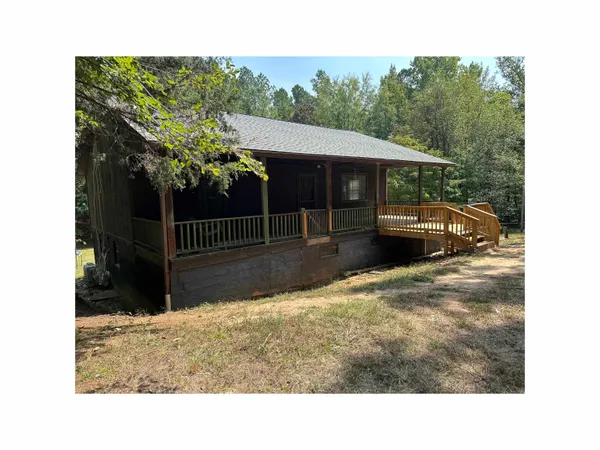 a view of house with backyard and sitting area