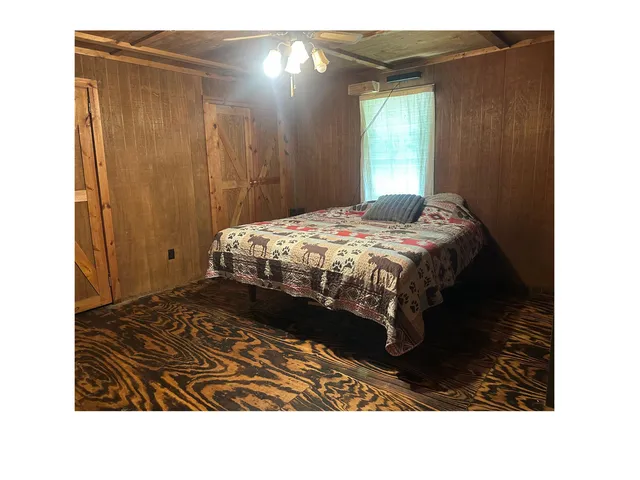 a room with a bed and a mirror