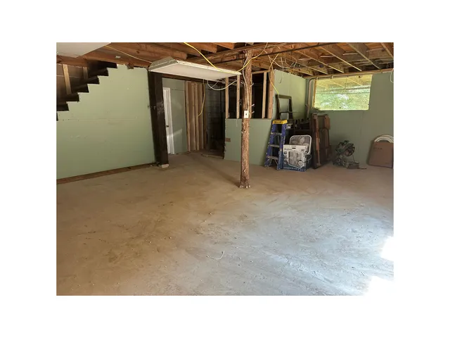a living room with furniture and a ceiling fan