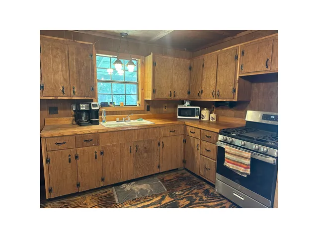 a kitchen with sink cabinets and window