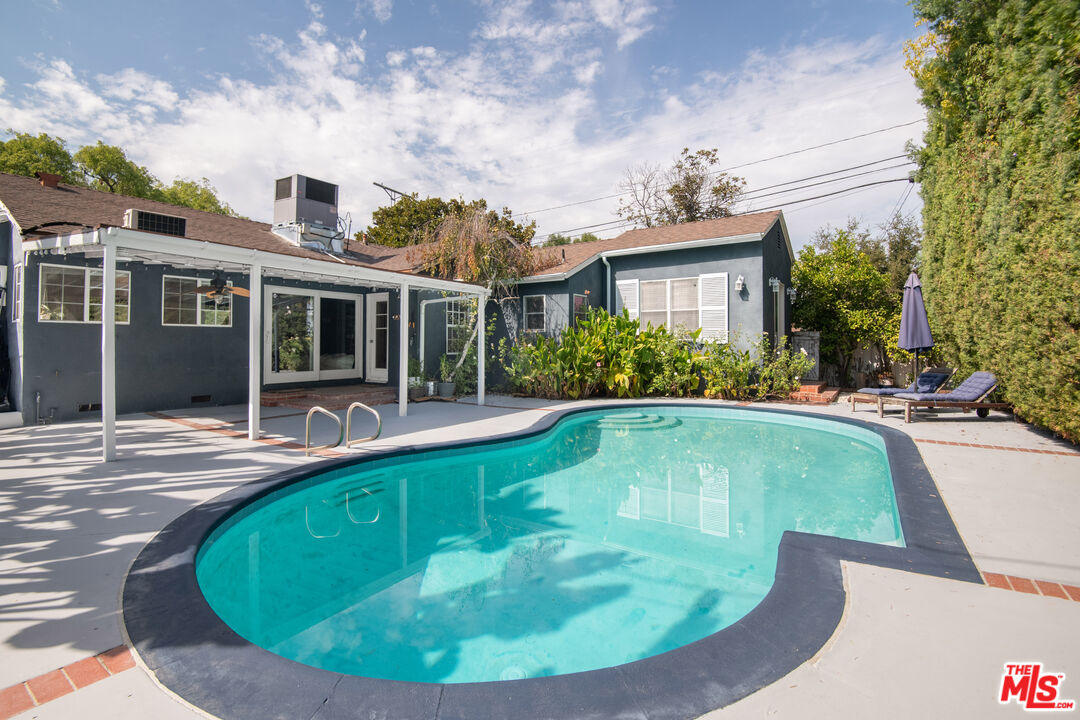 a view of a house with swimming pool and porch