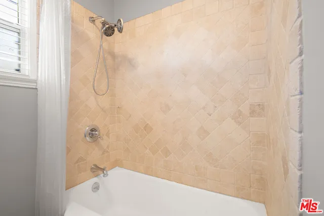 a bathroom with a shower and a bathtub