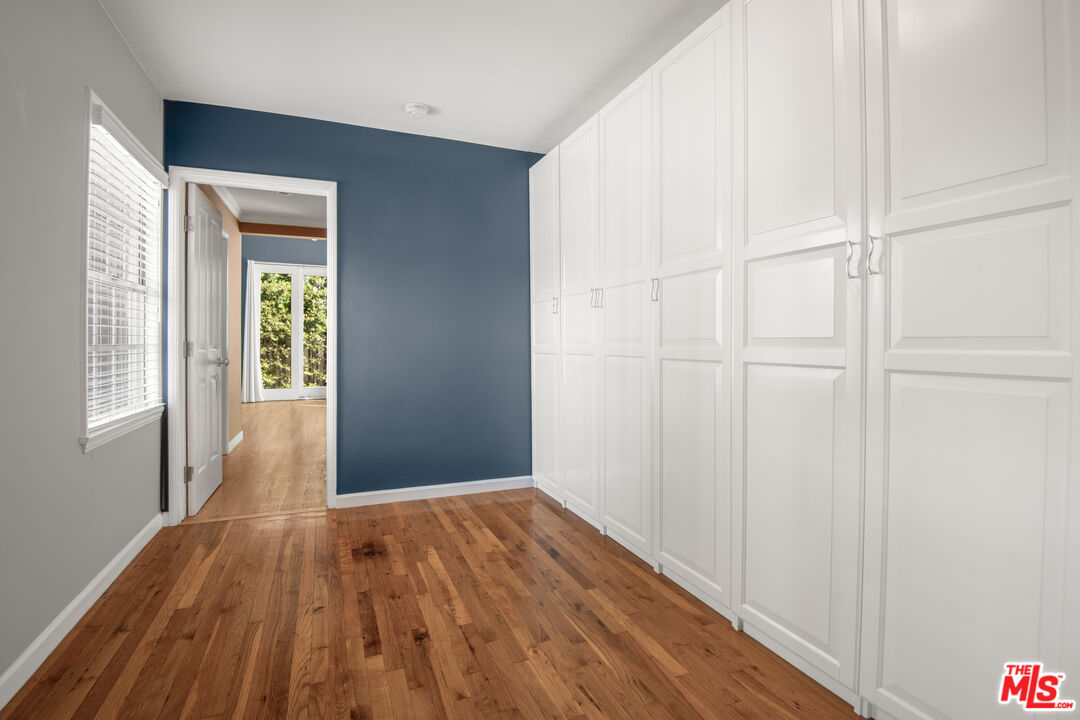 6218 Balcom Avenue Encino, CA 91316 - Photo 13 of 22 a view of an empty room with wooden floor and a window